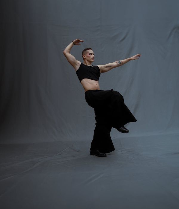 Man performing a sequence of slow, controlled exercises in a minimalist studio.